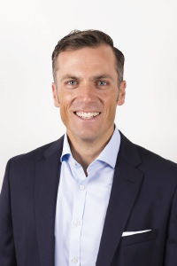 Headshot of smiling man in front of white background