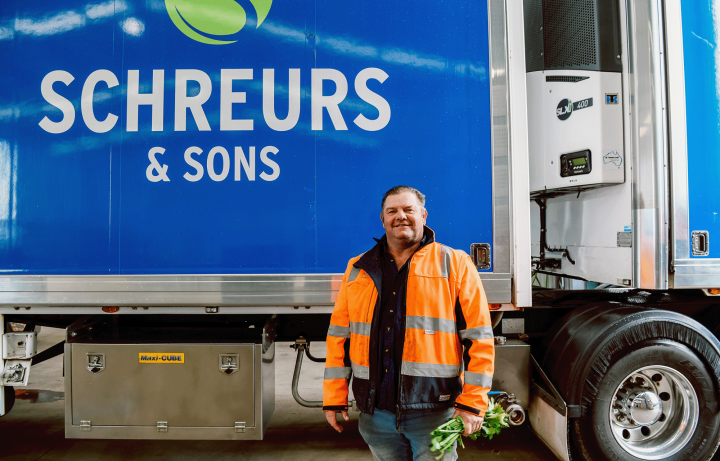 Man in high vis standing in front of a Shreurs branded truck