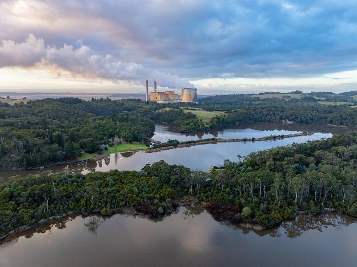 Power station in the background surrounded by water and forest