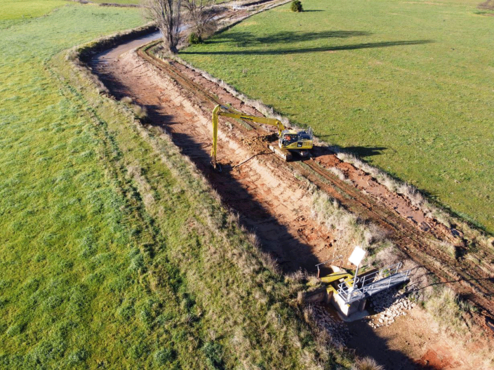 Channel being dug in a green field