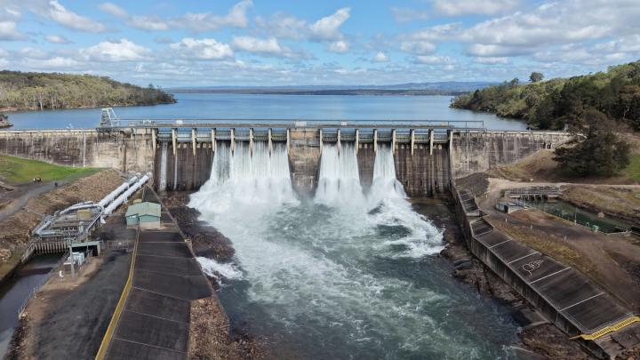 Aerial image of Glenmaggie Weir wall spilling water 